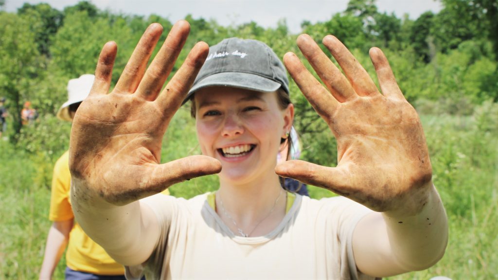 neighbourwoods volunteer showing off her dirty hands